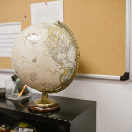 white and gold desk globe on black table