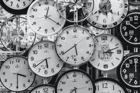 black and white photo of clocks